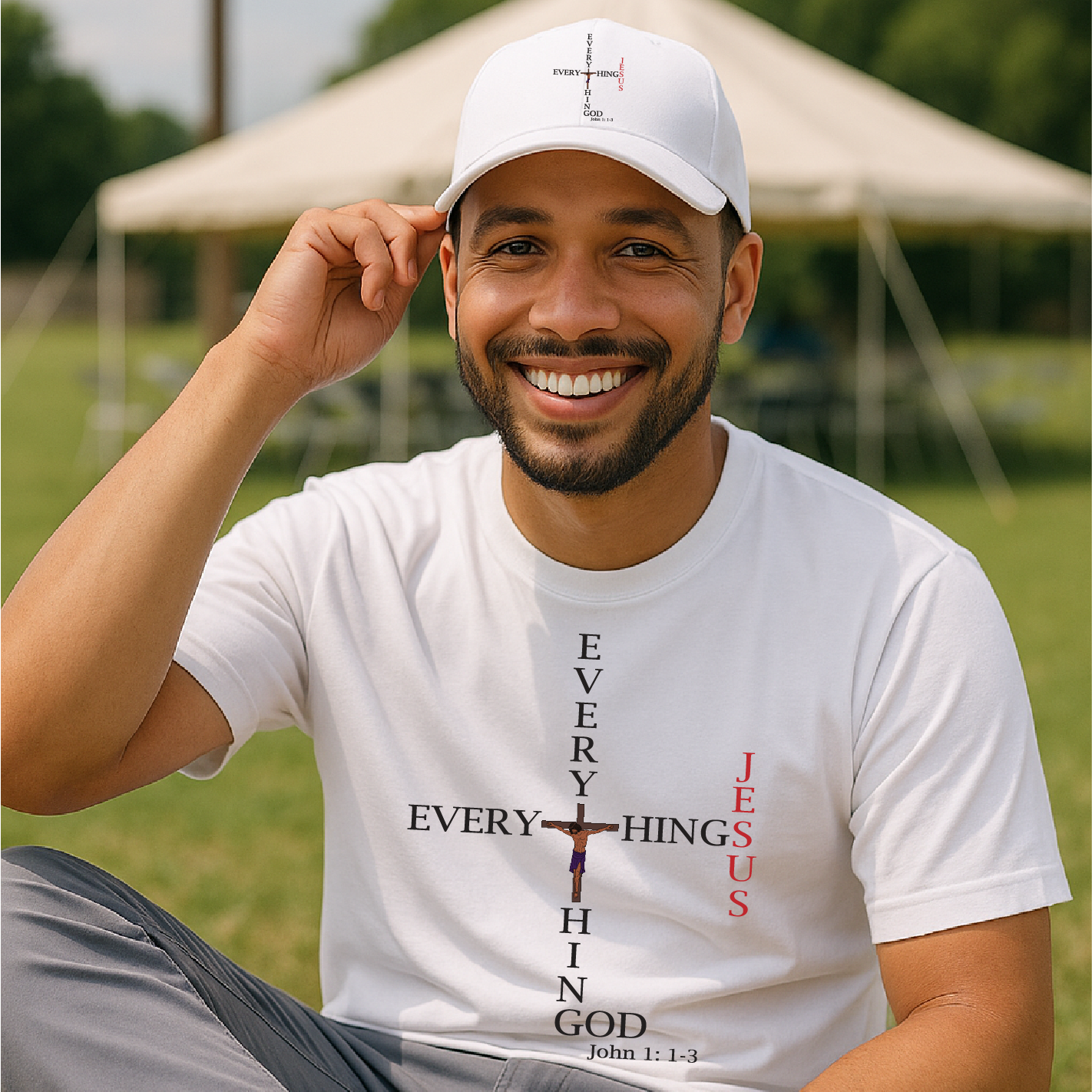 Man wearing a white t-shirt with religious text and design, sitting outdoors.